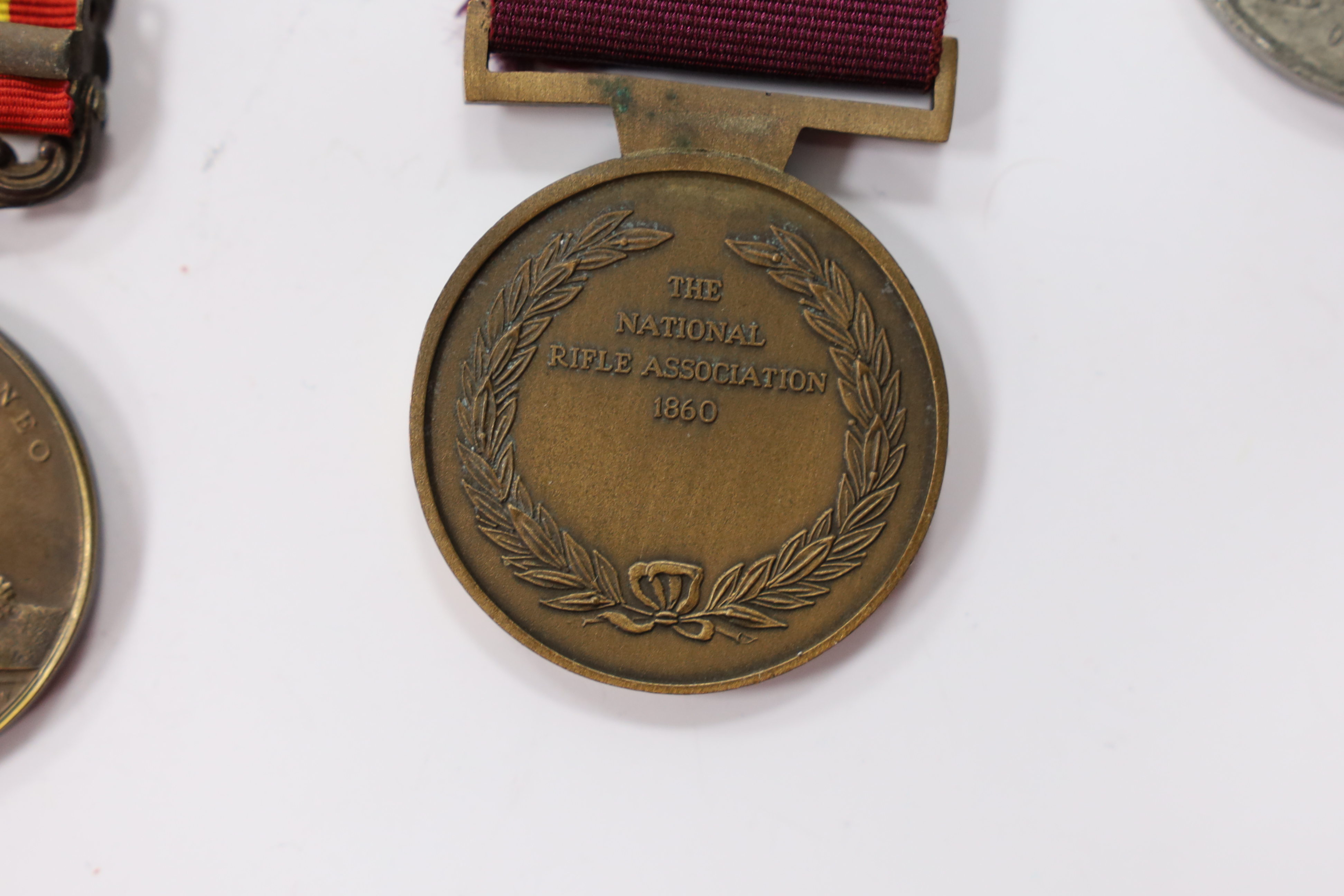 Assorted medals; two replica British North Borneo medals; Balaklava medallion; bronze GV medal; German China Campaign medal; bronze NRA medallion, unnamed